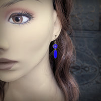 Blue Czech Glass Flower Bead Earrings with Metallic Finish and Antiqued Brass. Photographed on a mannequin for scale.