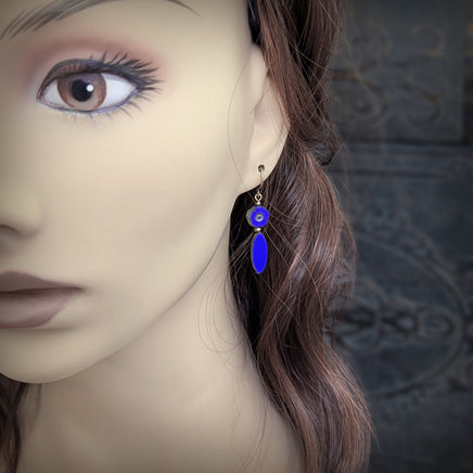 Blue Czech Glass Flower Bead Earrings with Metallic Finish and Antiqued Brass. Photographed on a mannequin for scale.
