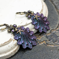 Iridescent purple and green Seashell Earrings with Antiqued Bronze Starfish charms and Pearl Clusters on top of the shells
