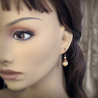 Handmade Butter Yellow Drop Earrings with Czech Crystal Pearls and Antiqued Copper Floral Accents. Photographed on a mannequin for scale