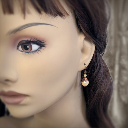 Handmade Butter Yellow Drop Earrings with Czech Crystal Pearls and Antiqued Copper Floral Accents. Photographed on a mannequin for scale