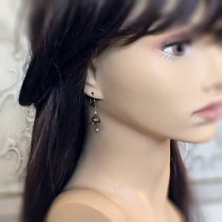 Dusty Pink Metal Flower Dangle Earrings mannequin view