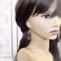 Long Green and Copper Earrings on mannequin