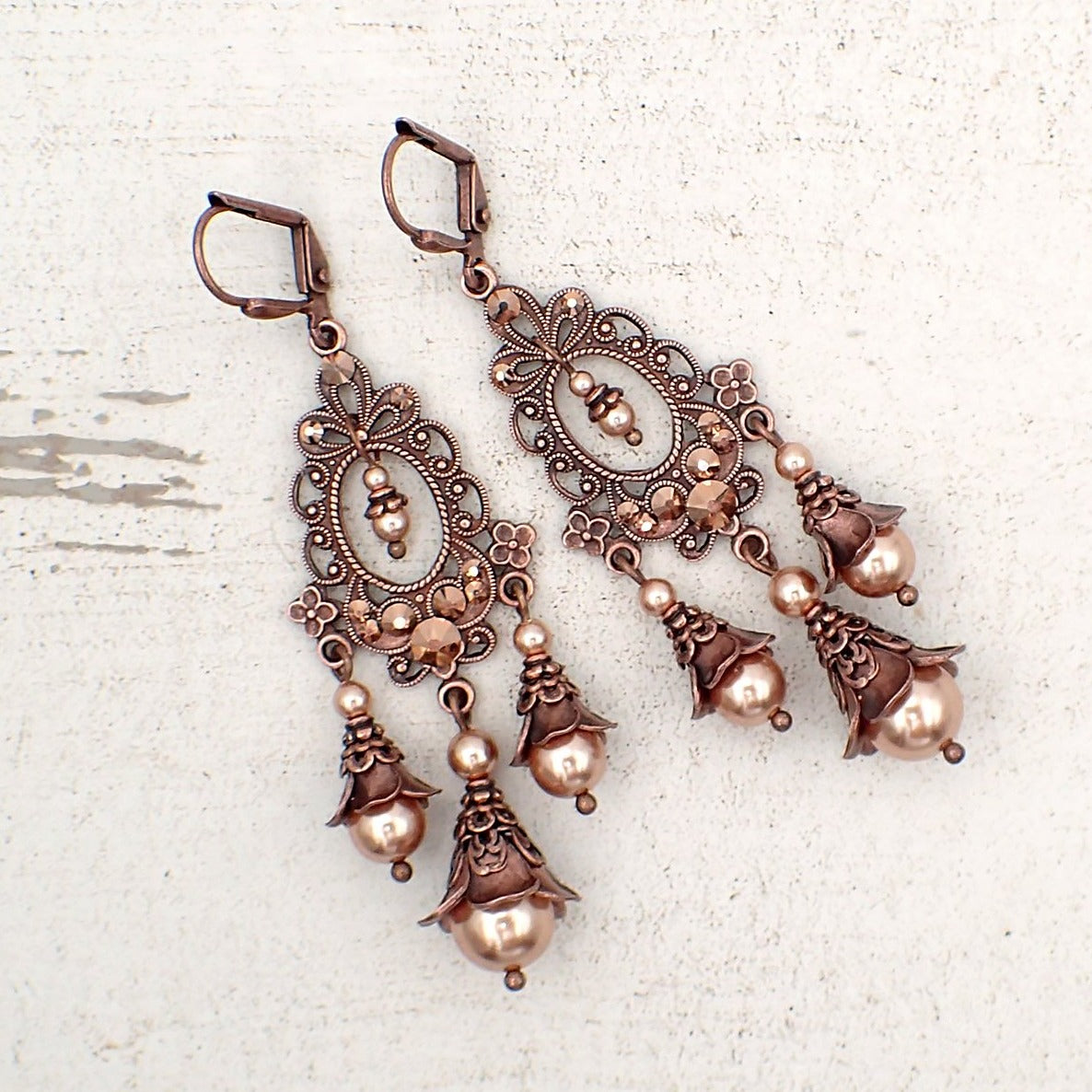 rose gold colored crystal pearl and copper chandelier earrings