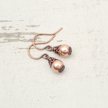 Dainty little rose gold-colored crystal pearls dressed with antiqued copper details.